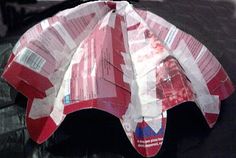 a red and white paper umbrella sitting on top of a table