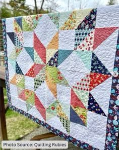 a quilt hanging on a fence with the words, photo source quilting rubies