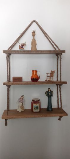 two shelves with figurines, candles and other items on them in the shape of a house