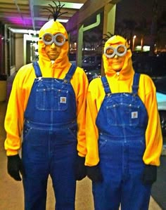 two people in yellow and blue overalls standing next to each other