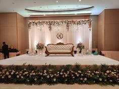 a couch sitting on top of a white table covered in flowers