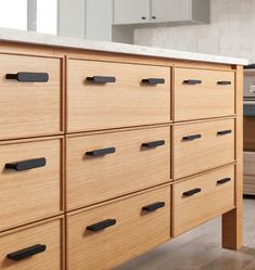 a kitchen with an island made out of wooden drawers