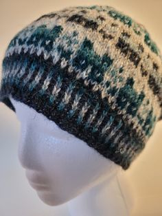 This hat is made from 100% Shetland wool grown and spun in Montana. It is handknit with 6 different colors - dark blue, light blue, teal, sky blue, white, grey. The pattern on the sides is of small Scottish houses known as crofts.  The top is of the hat is a star pattern. This is sized for a Woman Medium-Large.  As it is 100% wool, it is warm without being heavy. Note that Shetland wool is a rustic wool. As with any item that is hand knit with fine yarn, the hat should be handwashed and dried fl Scottish House, Shetland Wool, Fine Yarn, Star Pattern, Blue Teal, Star Patterns, Fair Isle, Winter Women, Blue Light