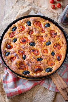 a pizza sitting on top of a pan covered in toppings