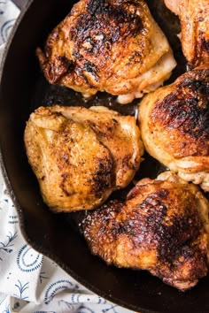 chicken thighs in a cast iron skillet ready to be cooked for the dinner guests