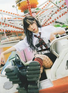 a woman sitting on top of a carnival ride