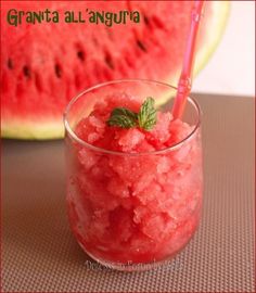 a glass filled with watermelon ice cream next to a slice of watermelon