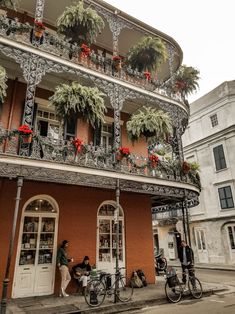 people sitting on bicycles in front of a building