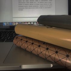 an open laptop computer sitting on top of a wooden table next to a pair of yoga mats