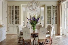 a dining room table with chairs and a chandelier