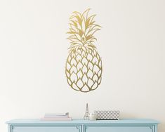 a wall decal with a gold pineapple design on it's sideboard