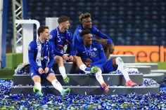 the soccer players are sitting on the bench with confetti in front of them