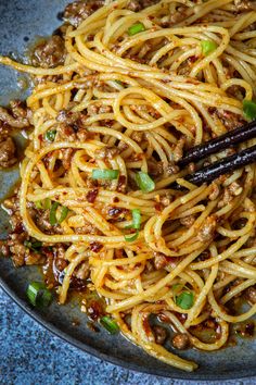 noodles with meat and green onions in a bowl