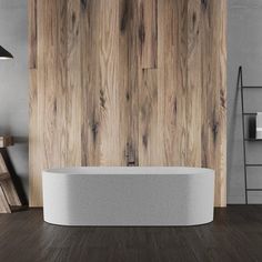 an empty bathtub in front of a wooden wall