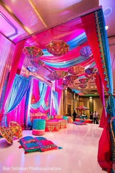 an elaborately decorated room with pink and blue drapes