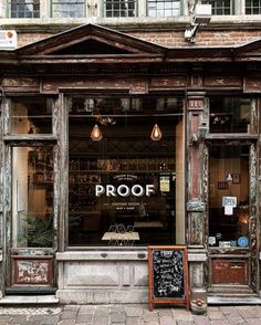 an old building with a sign that says proof on the front window and outside windows