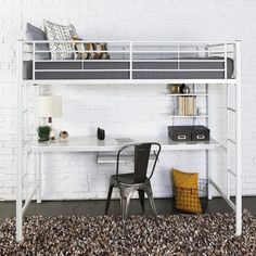 a white loft bed with a desk underneath it