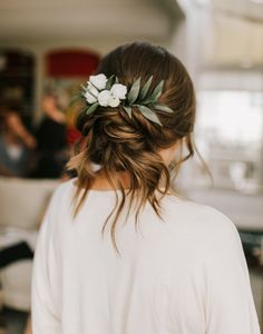 a woman wearing a flower in her hair