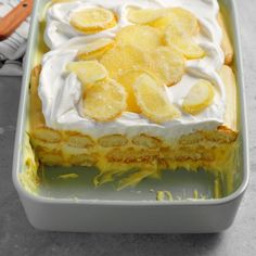 a cake in a pan topped with bananas and whipped cream