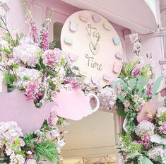 pink and white flowers decorate the entrance to a store