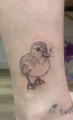 a small bird tattoo on the ankle