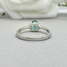 This beautiful ring is made from genuine 925 sterling silver with rhodium plating. Ring details- -The Main stone is an oval cut 7mm by 5mm Lab Created Paraiba Tourmaline Stone -Side stones are 1.3 Round simulated diamonds -Ring is casted in solid 925 sterling silver with rhodium plating (yellow gold and rose gold plated also available, please check the drop down menu for more options) -The Total face height of the ring measures 7mms and the band width measures 1.4mms -Each ring is handmade and m Paraiba Tourmaline Engagement Ring, Paraiba Tourmaline Ring, Garnet Wedding Rings, Dainty Wedding, Tourmaline Engagement Ring, Dainty Wedding Ring, Wedding Rings Photos, Wedding Rings Round, Simulated Diamond Rings