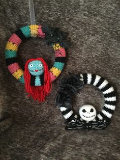 two knitted wreaths, one with a creepy doll and the other with a skeleton