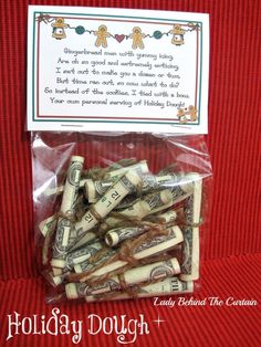 a bag filled with lots of money sitting on top of a red cloth covered table