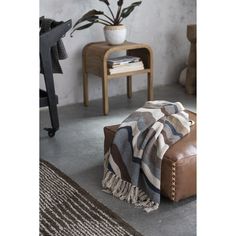 a living room with a couch, coffee table and potted plant