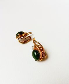 Pretty vintage clip on earrings. Faux gold casing with faux pearl and green stone. Approximately 1" tall. Lightweight. Green Clip-on Earrings For Formal Occasions, Green Clip-on Formal Earrings, Antique Green Clip-on Jewelry, Retro Green Clip-on Earrings, Vintage Green Clip-on Jewelry, Mid-century Formal Clip-on Earrings, Small Earrings Gold, Envelope Clutch Purse, Vintage Clip On Earrings