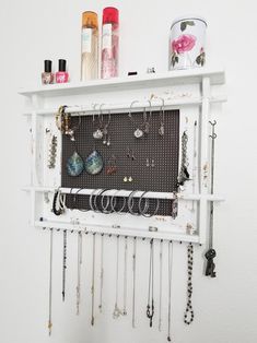 a white shelf filled with lots of jewelry