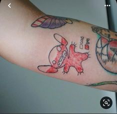 a person's arm with tattoos on it and an image of a cartoon character