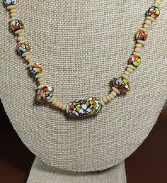 This is a fabulous beaded necklace consisting of little beige colored beads or stones and pretty decorative glass beads that remind me of stained glass in pretty colors of orange, red, white, black and blue.  This necklace has a screw in clasp although it does show a little green on edges as shown in photos.  Unfortunately, I do not know what type of beads these are or if they are genuine stones but this is a gorgeous necklace.  This vintage piece measures approximately 12 inches long. Beige Jewelry With Colorful Beads For Jewelry Making, Adjustable Beige Beaded Necklace With Large Beads, Beige Necklace With Colorful Round Beads, Adjustable Cream Necklace With Colorful Beads, Adjustable Glass Beaded Necklaces With Wooden Beads, Adjustable Cream Beaded Necklaces With Large Beads, Bohemian Beaded Necklaces With Colorful Beads In Beige, Cream Beaded Necklace With Round Beads, Adjustable Beige Necklace With Colorful Beads