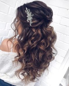 a woman wearing a hair comb with flowers on it's head and curls in her hair