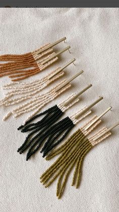 an assortment of beaded pins and needles on a piece of white fabric with text overlaying the image