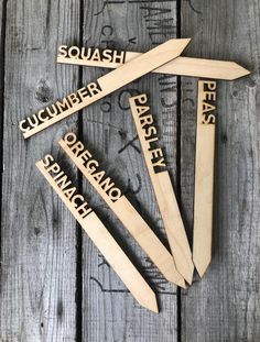 four wooden spoons with the words squash, cucumber, parsley, organic and spanish on them