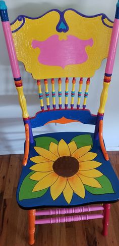 a child's wooden chair painted with bright colors