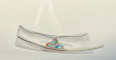 an upside down glass object with beads in it's center and on its side