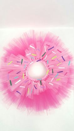 a pink tutu with sprinkles on it and a hole in the middle