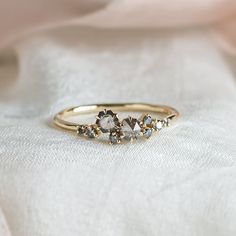 three stone ring sitting on top of a white cloth