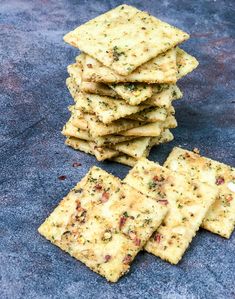 crackers stacked on top of each other on a blue tablecloth with one cracker in the middle