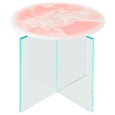 a round glass table with pink and white marble on it's top, against a white background