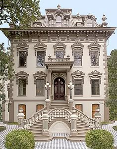 a large white house with many windows and balconies