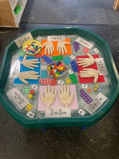 a table with hands and numbers on it in the shape of a board game that is made out of legos