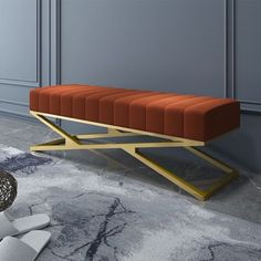 an orange bench sitting on top of a marble floor