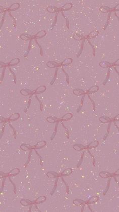 a pink wallpaper with bows on it's sides and sparkles in the background