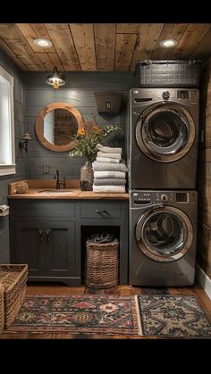 a washer and dryer in a small room with wood paneling on the walls