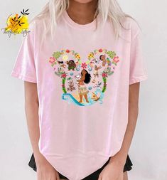 a woman wearing a pink shirt with cartoon characters on it