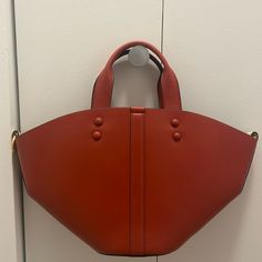 Tory Burch Cognac Mini Tote. Comes With Crossbody Strap And Bag Charm. New With Tags And Dust Bag. Has Never Been Worn Before. Red Top Handle Bucket Bag With Gold-tone Hardware, Modern Red Bucket Bag With Detachable Handle, Red Bucket Bag With Top Carry Handle, Red Bucket Bag With Top Carry Handle For Shopping, Red Rectangular Bucket Bag With Gold-tone Hardware, Red Double Handle Bucket Bag With Top Carry, Chic Red Bucket Bag With Top Carry Handle, Tan Bucket Bag With Detachable Strap For Shopping, Tory Burch Ella