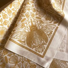 three napkins with gold designs on them